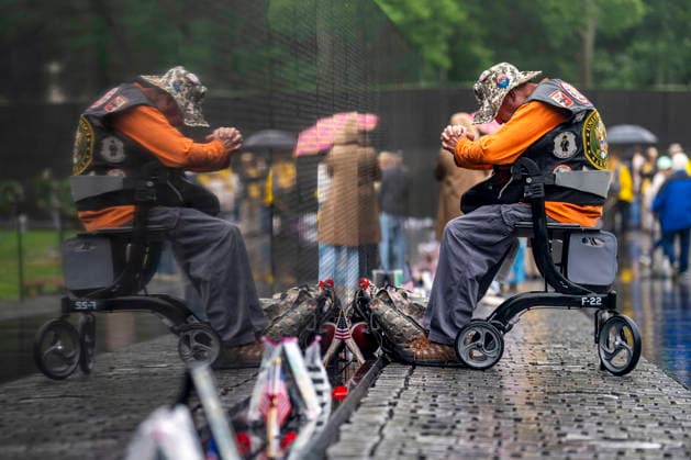 A Gulf War veteran pays his respects at the Vietnam Veterans Memorial on Memorial Day in Washington, DC on Monday, May 25, 2026.  WAP20260525303 BONNIExCASH