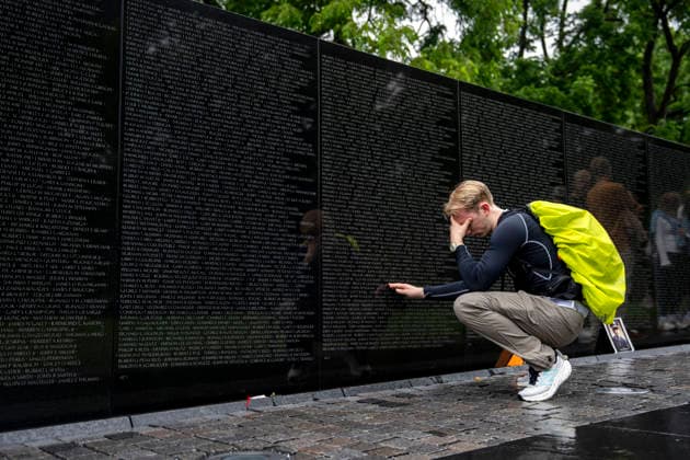 A man becomes emotional touching a name on the Vietnam Veterans Memorial on Memorial Day in Washington, DC on Monday, May 25, 2026.  WAP20260525309 BONNIExCASH
