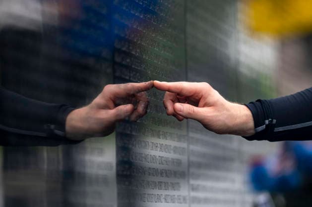 A man touches the a name on the Vietnam Veterans Memorial on Memorial Day in Washington, DC on Monday, May 25, 2026.  WAP20260525310 BONNIExCASH