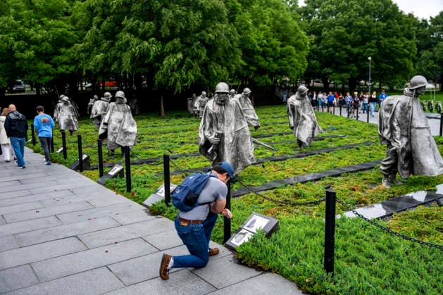 A man reads information about Prisoners of War and those Missing in Acton at the Korean War Memorial on Memorial Day in Washington, DC on Monday, May 25, 2026.  WAP20260525328 BONNIExCASH