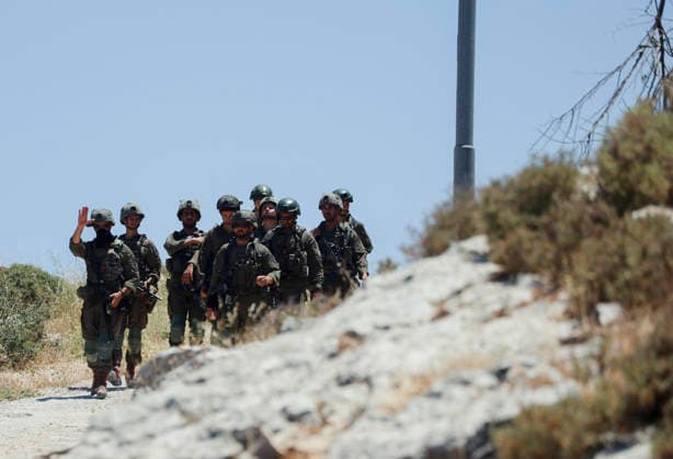 Israeli Demolition West Bank Family Displaced Eid Al-Adha A group of armed Israeli soldiers walks across a dirt road in Nahhalin, occupied West Bank, on May 25, 2026, after a demolition operation. The demolition, carried out by Israeli forces who stated the structure was built without a permit, displaced an eight-member Palestinian family just two days before the Islamic holiday of Eid al-Adha. Bethlehem West Bank Palestinian Territories Copyright: xMosabxShawerx
