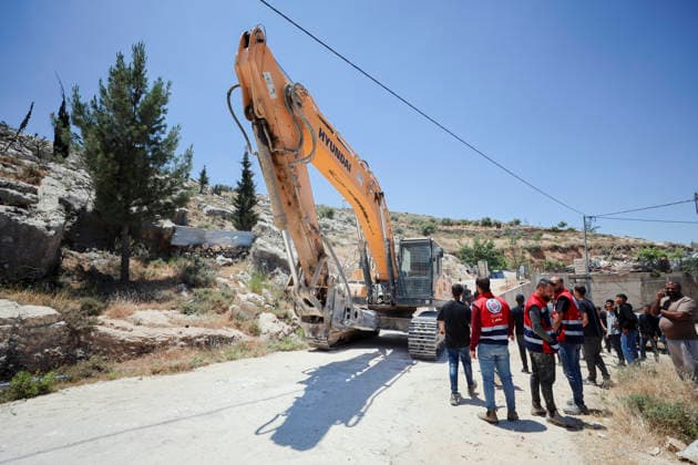 Israeli Demolition West Bank Family Displaced Eid Al-Adha People stand near a demolition excavator following an operation in Nahhalin, occupied West Bank, on May 25, 2026. The demolition, carried out by Israeli forces who stated the structure was built without a permit, displaced an eight-member Palestinian family just two days before the Islamic holiday of Eid al-Adha. Bethlehem West Bank Palestinian Territories Copyright: xMosabxShawerx