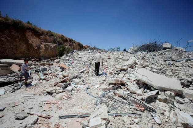 Israeli Demolition West Bank Family Displaced Eid Al-Adha An elderly man and a boy walk across the rubble of a destroyed building in Nahhalin, occupied West Bank, on May 25, 2026. The demolition, carried out by Israeli forces who stated the structure was built without a permit, displaced an eight-member Palestinian family just two days before the Islamic holiday of Eid al-Adha. Bethlehem West Bank Palestinian Territories Copyright: xMosabxShawerx