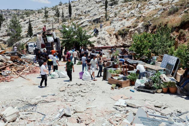 Israeli Demolition West Bank Family Displaced Eid Al-Adha People gather around salvaged furniture and load belongings onto a truck following a home demolition in Nahhalin, occupied West Bank, on May 25, 2026. The demolition, carried out by Israeli forces who stated the structure was built without a permit, displaced an eight-member Palestinian family just two days before the Islamic holiday of Eid al-Adha. Bethlehem West Bank Palestinian Territories Copyright: xMosabxShawerx