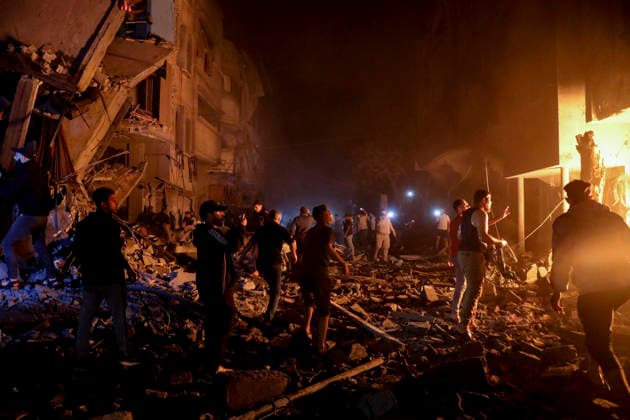 Nuseirat Homes Destroyed Airstrike May 25 Palestinian residents gather as fire billows from a damaged building following an Israeli airstrike in Nuseirat in the central Gaza Strip on May 25, 2026. It was reported that five houses were destroyed and dozens more damaged in the strikes. Nuseirat Gaza Strip Palestinian Territories Copyright: xAhmedxYounisx