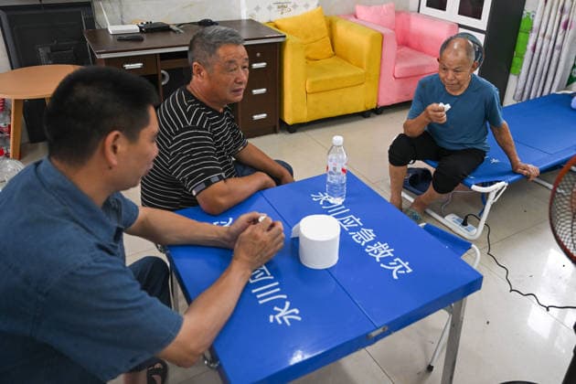 CHONGQING, CHINA - MAY 25: Disaster-affected residents sit and talk at a resettlement site set up in a school after a heavy rainstorm hit Yongchuan District on May 25, 2026 in Chongqing, China. Local authorities have deployed over 1,800 rescue workers to conduct search and rescue operations and hazard inspections after severe storms and flash floods hit the area from the night of May 23 to the early morning of May 24.  Copyright: xChinaxNewsxServicex 111643998144