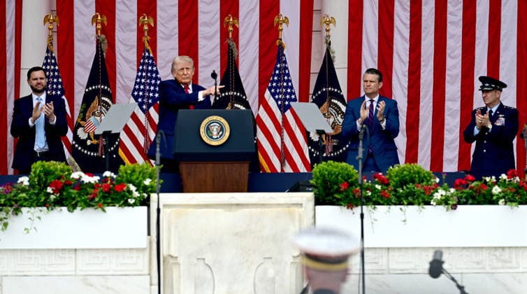 Trump Remarks on Memorial Day at Arlington National Cemetery United States Vice President JD Vance, left, United States Secretary of War Pete Hegseth, right center, and United States Air Force General Dan Caine, Chair, Joint Chiefs of Staff applaud as US President Donald J Trump, left center, delivers remarks in the Amphitheater after laying a wreath at the Tomb of the Unknowns at Arlington National Cemetery in Arlington, Virginia on Memorial Day, Monday, May 25, 2026. Credit: CNP AdMedia Arlington Virginia United States of America EDITORIAL USE ONLY  Copyright: xx AdMediax admphotostwo992172