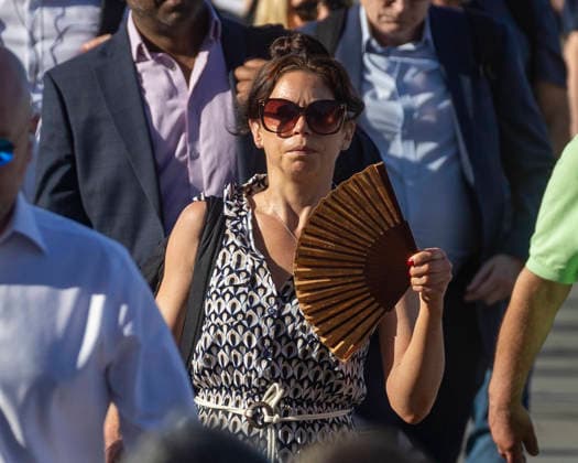May 26, 2026, London, London, UK: London, UK. A commuter crossing London Bridge cools down with a folding fan. According to the weather office, it will be another fine and dry day. High of 35Ã‚Â°C. London UK  - ZUMAl94_ 20260526_zaf_l94_009 Copyright: xMarcinxNowakx