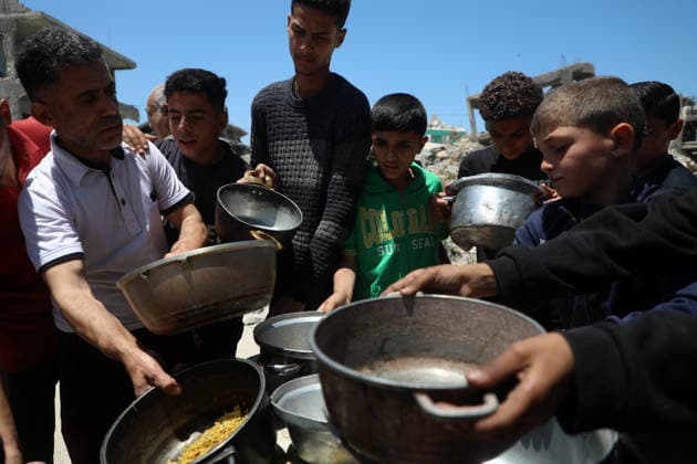 Palestinians line up to receive food inside the Jabalia refugee camp in the northern Gaza Strip. Jabalia - May 23, 2026: Palestinians line up to get food inside the Jabalia refugee camp in the northern Gaza Strip, near the Yellow Line. This line consists of concrete blocks placed by the Israeli army along the length of the Strip from north to south. The Israeli army controls more than 60% of the Strip s area. (Photo by Rizek ELdremle ) Jabalia Copyright: xx