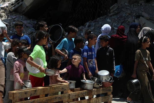 Palestinians line up to receive food inside the Jabalia refugee camp in the northern Gaza Strip. Jabalia - May 23, 2026: Palestinians line up to get food inside the Jabalia refugee camp in the northern Gaza Strip, near the Yellow Line. This line consists of concrete blocks placed by the Israeli army along the length of the Strip from north to south. The Israeli army controls more than 60% of the Strip s area. (Photo by Rizek ELdremle ) Jabalia Copyright: xx