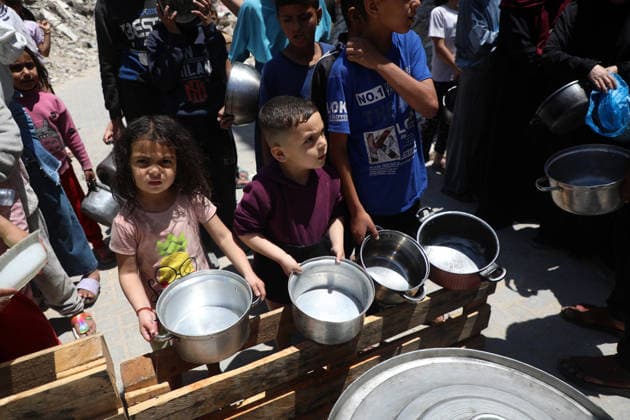 Palestinians line up to receive food inside the Jabalia refugee camp in the northern Gaza Strip. Jabalia - May 23, 2026: Palestinians line up to get food inside the Jabalia refugee camp in the northern Gaza Strip, near the Yellow Line. This line consists of concrete blocks placed by the Israeli army along the length of the Strip from north to south. The Israeli army controls more than 60% of the Strip s area. (Photo by Rizek ELdremle ) Jabalia Copyright: xx