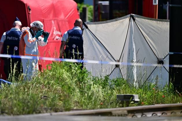 Police pictured at the scene of an accident between a train and a minivan, at the railway crossing Vierhuizen, in Buggenhout, Tuesday 26 May 2026. The accident happened around 8:15 am. Several people have been killed. According to initial reports, the level crossing was closed at the time of the accident.  DIRKxWAEM 175092825