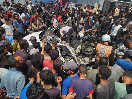 Israeli airstrike hits vehicle in Al-Mawasi despite ceasefire agreement KHAN YUNIS, PALESTINE - MAY 26: (EDITOR S NOTE: Image depicts graphic content) Palestinians gather around the wreckage of a targeted vehicle after the Israeli army violated the ceasefire and launched an airstrike in the Al-Mawasi area of Khan Yunis, Gaza Strip, on May 26, 2026. Dead and injured individuals were reported following the attack, while civil defense teams worked to collect body parts from the destroyed vehicle. Hani Alshaer Anadolu Khan Yunis Gaza. Editorial use only. Please get in touch for any other usage.  Copyright: x2026xAnadoluxHanixAlshaerx