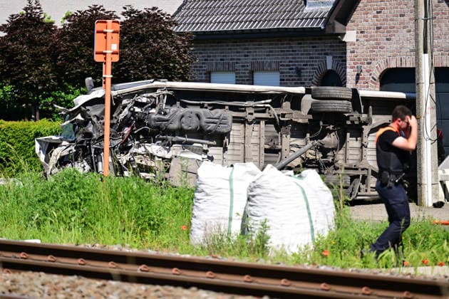 (260526) -- BUGGENHOUT, May 26, 2026 -- A man walks past the scene of a school bus and train collision accident in Buggenhout, East Flanders, Belgium, May 26, 2026. Four people were killed on Tuesday morning after a school bus rammed into a train at a crossing in the city of Buggenhout, the East Flanders province of Belgium, local media reported. ( Handout via Xinhua) (SpotNews) BELGIUM-BUGGENHOUT-SCHOOL BUS COLLISION DIRKxWAEM BELGAxPHOTO 