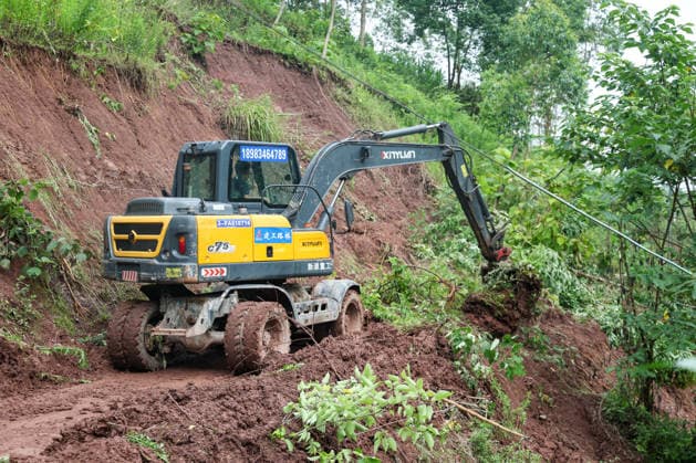 (260526) -- CHONGQING, May 26, 2026 -- Workers clear a landslide-blocked road at Xiangtanzi Village of Shuangshi Town, Yongchuan District of southwest China s Chongqing Municipality, May 26, 2026. From Saturday night to early Sunday morning, a sudden and extreme catastrophic rainstorm struck Yongchuan, triggering flash floods and geological disasters in multiple areas of this district. After the disaster occurred, the local authorities immediately activated the emergency response mechanism, coordinated rescue forces from all sides and made every effort to carry out rescue operations and infrastructure restoration. Rescue and response efforts are still underway. ) CHINA-CHONGQING-FLOOD-RESCUE (CN) HuangxWei 