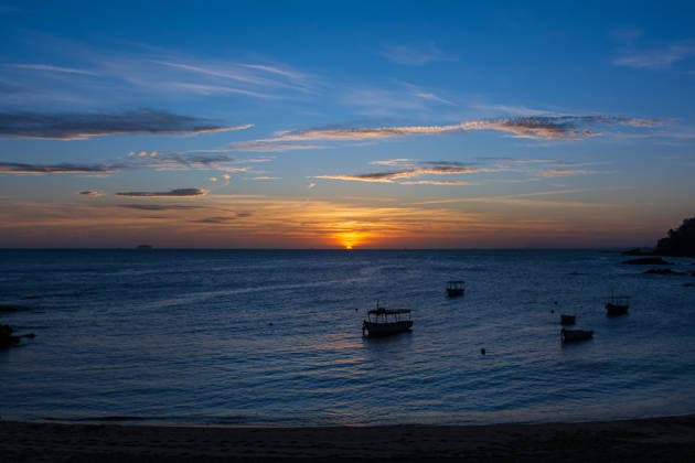 Boats anchored in calm seas during sunset, with a colorful sky and tranquil atmosphere on the Brazilian coast. Salvador Bahia Brazil Copyright: xTHALESxANTONIOx Paciencia, Rio Vemelho 272