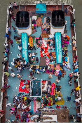 May 26, 2026, Dhaka, Munshiganj, Bangladesh: MUNSHIGANJ, BANGLADESH Ã¢â‚¬ MAY 2026: An aerial top-down view captured from the Mukterpur Bridge in Munshiganj shows overcrowded passenger ferries (locally known as launches) traveling along the river, packed with thousands of home-bound people leaving Dhaka s Sadarghat terminal. Every year, ahead of the Muslim festival of Eid-ul-Adha, millions of people working in the capital city Dhaka endure hectic journeys and brave overcrowded public transport to return to their ancestral villages and celebrate the festival with their families. Many passengers who fail to secure indoor cabins opt to spend the hours-long journey on the open top decks, layout out colorful blankets, mats, and sheets to rest  - ZUMAa259 20260526_zip_a259_001 Copyright: xRayhanxAhmedx