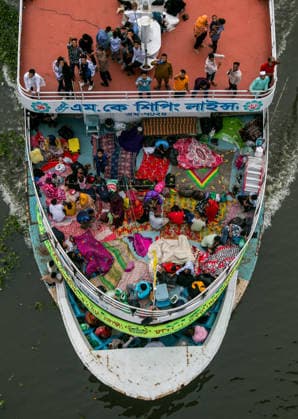 May 26, 2026, Dhaka, Munshiganj, Bangladesh: MUNSHIGANJ, BANGLADESH Ã¢â‚¬ MAY 2026: An aerial top-down view captured from the Mukterpur Bridge in Munshiganj shows overcrowded passenger ferries (locally known as launches) traveling along the river, packed with thousands of home-bound people leaving Dhaka s Sadarghat terminal. Every year, ahead of the Muslim festival of Eid-ul-Adha, millions of people working in the capital city Dhaka endure hectic journeys and brave overcrowded public transport to return to their ancestral villages and celebrate the festival with their families. Many passengers who fail to secure indoor cabins opt to spend the hours-long journey on the open top decks, layout out colorful blankets, mats, and sheets to rest  - ZUMAa259 20260526_zip_a259_002 Copyright: xRayhanxAhmedx