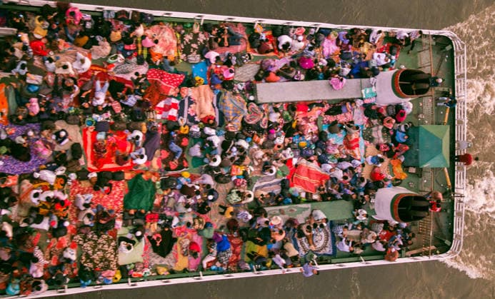 May 26, 2026, Dhaka, Munshiganj, Bangladesh: MUNSHIGANJ, BANGLADESH Ã¢â‚¬ MAY 2026: An aerial top-down view captured from the Mukterpur Bridge in Munshiganj shows overcrowded passenger ferries (locally known as launches) traveling along the river, packed with thousands of home-bound people leaving Dhaka s Sadarghat terminal. Every year, ahead of the Muslim festival of Eid-ul-Adha, millions of people working in the capital city Dhaka endure hectic journeys and brave overcrowded public transport to return to their ancestral villages and celebrate the festival with their families. Many passengers who fail to secure indoor cabins opt to spend the hours-long journey on the open top decks, layout out colorful blankets, mats, and sheets to rest - ZUMAa259 20260526_zip_a259_005 Copyright: xRayhanxAhmedx