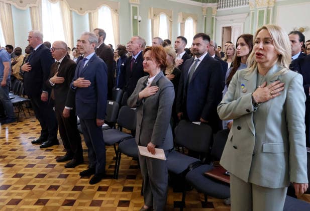 Forum Ukraine Africa Past, Present and Future of Relations held in Kyiv Participants place their hands over their hearts during the national anthem of Ukraine at the forum Ukraine Africa: Past, Present and Future of Relations in Kyiv, Ukraine, on May 26, 2026. The event was organized to mark Africa Day 2026 in Ukraine at the Hennadii Udovenko Diplomatic Academy of Ukraine under the Ministry of Foreign Affairs, Credit:Pavlo Bahmut Ukrinform Avalon Ukraine, Kyiv  Copyright: xPavloxBahmutx xUkrinformx xAvalonx 1105811901