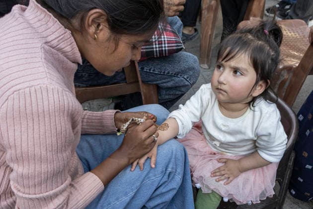 May 26, 2026, Srinagar, Jammu And Kashmir, India: A mehendi artist applies henna to a childÃ¢â‚¬â ¢s hand at a market ahead of Eid al-Adha in Srinagar, the summer capital of Jammu and Kashmir. Srinagar India - ZUMAf191 20260526_zip_f191_006 Copyright: xUmarxFarooqx