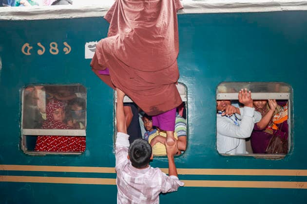 May 26, 2026, Tongi, Bangladesh: Bangladeshi Muslim passengers struggle to board an overcrowded train as they travel home ahead of the upcoming Eid al-Adha festival at a railway station in Tongi, near Dhaka, Bangladesh, Monday, May 26, 2024. Millions of people are expected to leave the capital in one of the countryÃ¢â‚¬â ¢s largest annual holiday exoduses to celebrate Eid with their families in rural areas. Tongi Bangladesh - ZUMAd117 20260526_fap_d117_038 Copyright: xSuvraxKantixDasx