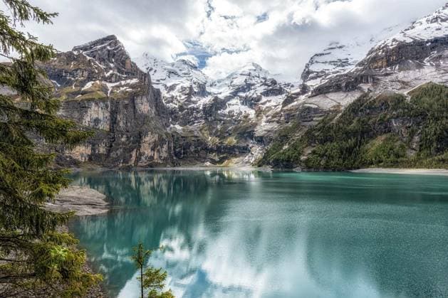 The view of Oeschinenee Lake and Oeschinen valley amongst Bernese Alps mountain tops. Famous tourist attraction in Switzerland Copyright: xaaron90311x Panthermedia64609064.jpg
