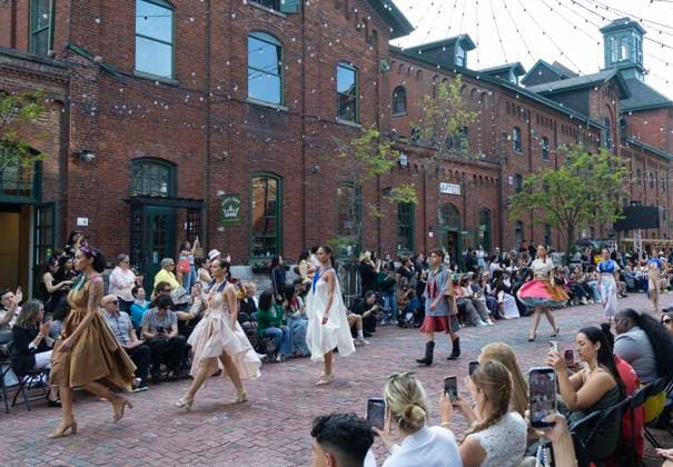 (260527) -- TORONTO, May 27, 2026 -- Models present creations on a pedestrian street during the Fashion Art Toronto s Fashion Week Spring Summer 2026 in Toronto, Canada, on May 26, 2026. (Photo by Xinhua) CANADA-TORONTO-FASHION WEEK ZouxZheng 