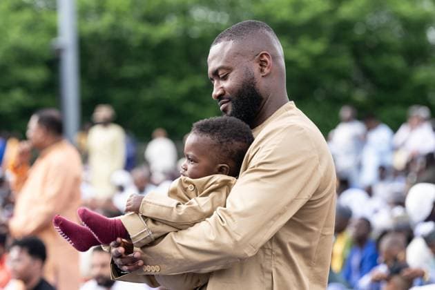 May 27, 2026, New York, New York, USA: A man with his son prepares to pray with Mayor Zohran Mamdani during Eid Al-Adha holiday prayers at The Yancy Track & Field in New York, NY on May 27, 2026. Hundreds of men, women and children attended wearing clean, colorful and expensive traditional clothes. Eid al-Adha translates from Arabic to Festival of Sacrifice is one of the most important holidays in the Islamic calendar. It honors the Prophet Ibrahim s (Abraham s in Judaism) absolute obedience to God, commemorating his willingness to sacrifice his son as an act of submission before God provided a ram to sacrifice instead. New York USA - ZUMAr339 20260527_znp_r339_028 Copyright: xLevxRadinx