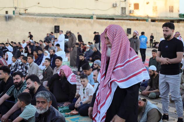 Eid Al-Adha Prayers Idlib Men stand among people sitting on prayer rugs before Eid al-Adha prayers in Idlib, Syria, on May 27, 2026. Eid al-Adha, or the Feast of Sacrifice, is one of the most important holidays in the Islamic calendar, commemorating the willingness of Prophet Ibrahim to sacrifice his son. The event is traditionally marked worldwide by communal prayers, family gatherings, acts of charity, and the slaughtering of livestock. Idlib Idlib Syria Copyright: xOmarxAlbawx