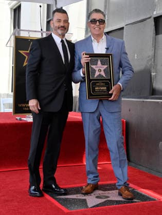 Comedy, actor, radio personality and television host Adam Corolla holds a replica plaque as he is joined by Jimmy Kimmel (L) during an unveiling ceremony honoring him with the 2,846th star on the Hollywood Walk of Fame in Los Angeles on Wednesday, May 27, 2026.  LAP2026052708 JIMxRUYMEN