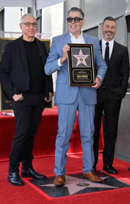 Comedy, actor, radio personality and television host Adam Corolla holds a replica plaque as he is joined by Dr. Drew Pinsky (L) and Jimmy Kimmel during an unveiling ceremony honoring him with the 2,846th star on the Hollywood Walk of Fame in Los Angeles on Wednesday, May 27, 2026.  LAP2026052704 JIMxRUYMEN