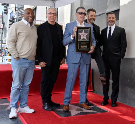 Comedy, actor, radio personality and television host Adam Corolla holds a replica plaque as he is joined by Byron Allen, Drew Pinsky, Joel McHale, and Jimmy Kimmel (L-R) during an unveiling ceremony honoring him with the 2,846th star on the Hollywood Walk of Fame in Los Angeles on Wednesday, May 27, 2026.  LAP2026052706 JIMxRUYMEN