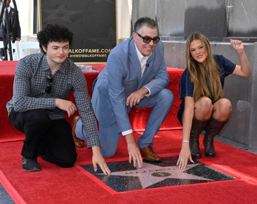 Comedy, actor, radio personality and television host Adam Corolla is joined by his son Santino Richard Carolla (L) and daughter Natalia Carolla during an unveiling ceremony honoring him with the 2,846th star on the Hollywood Walk of Fame in Los Angeles on Wednesday, May 27, 2026.  LAP2026052712 JIMxRUYMEN