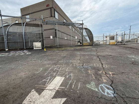 May 27, 2026, Newark, New Jersey, USA: Chalked graffiti with the words Ã’free them all!!!O marks the pavement outside of the Delaney Hall ICE detention center after a night of violent clashes between ICE agents and anti-ICE protestors. Detainees inside continue their hunger and labor strike over inhumane conditions and due process violations. Newark USA - ZUMAd155 20260527_znp_d155_006 Copyright: xSuexDorfmanx