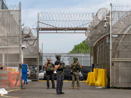 May 27, 2026, Newark, New Jersey, USA: ICE agents wearing bullet-proof vests stand outside of Delaney Hall ICE detention center as detainees inside continue their hunger and labor strike over inhumane conditions and due process violations. Supporters of the detainees are nearby. Newark USA - ZUMAd155 20260527_znp_d155_008 Copyright: xSuexDorfmanx