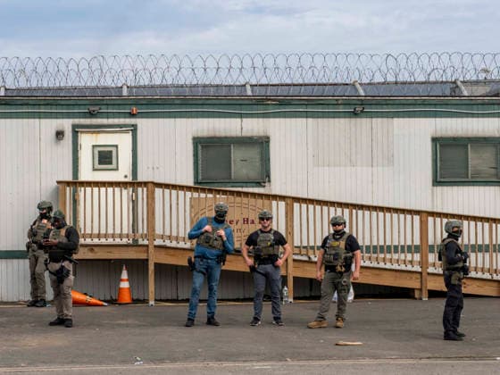 May 27, 2026, Newark, New Jersey, USA: ICE agents wearing bullet-proof vests stand outside of Delaney Hall ICE detention center as detainees inside continue their hunger and labor strike over inhumane conditions and due process violations. Supporters of the detainees are nearby. Newark USA - ZUMAd155 20260527_znp_d155_014 Copyright: xSuexDorfmanx