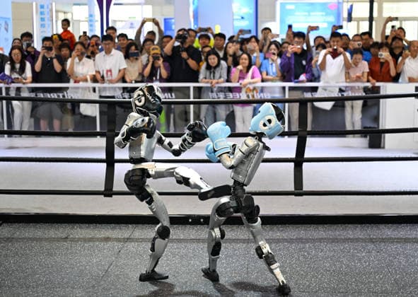 (260528) -- TIANJIN, May 28, 2026 -- People watch humanoid robots of Unitree Robotics boxing at the World Intelligence Expo 2026 in Tianjin, north China, May 28, 2026. Themed Intelligence: Extensive Development Space, Sustainable Growth Driver, the World Intelligence Expo 2026 kicked off here on Thursday. ) CHINA-TIANJIN-WORLD INTELLIGENCE EXPO (CN) SunxFanyue 