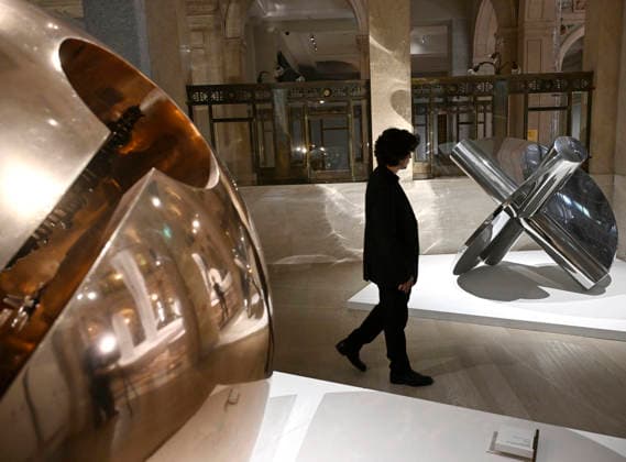 May 28, 2026, Milan, Italy: A visitor views artworks featured in the retrospective exhibition Arnaldo Pomodoro. Una vita (Arnaldo Pomodoro. A Life) during a preview at the Gallerie d Italia museum, MIlan, Italy, 28 May 2026. The exhibition retraces the career of the Italian sculptor and goldsmith from his early days in the mid-1950s to his most recent experiments in the 2000s. ANSA DANIEL DAL ZENNARO. Milan Italy  - ZUMAa110 20260528_zaf_a110_001 Copyright: xDanielxDalxZennarox