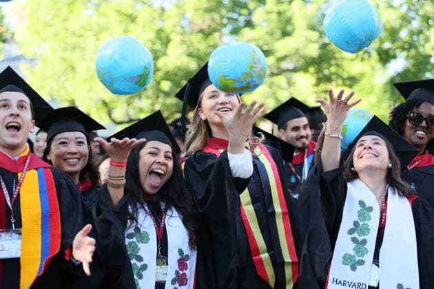 Crown Princess Elisabeth (C) and her fellow graduates celebrate with inflatable globes, at a Harvard university-wide celebration at Harvard Yard, part of the Class of 2026 graduation days in Harvard University, in Cambridge, USA, Thursday 28 May 2026.  BENOITxDOPPAGNE 175270524