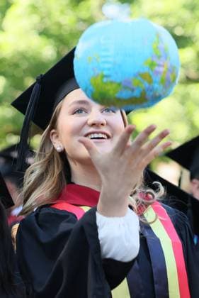 Crown Princess Elisabeth pictured with an inflatable globe during a Harvard university-wide celebration at Harvard Yard, part of the Class of 2026 graduation days in Harvard University, in Cambridge, USA, Thursday 28 May 2026.  BENOITxDOPPAGNE 175270545