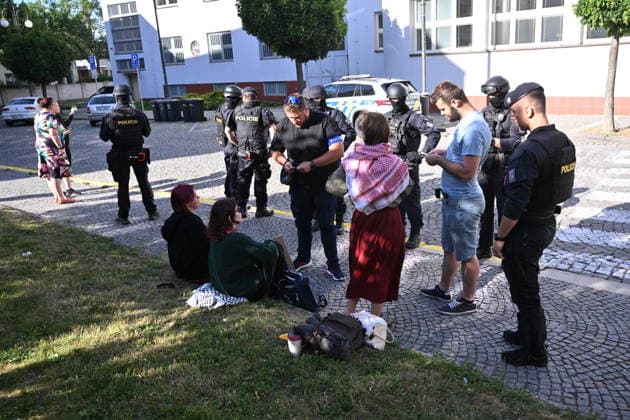 The situation in front of the District Court in Pardubice, where a custody hearing is underway with a man accused of intentionally setting fire to the LPP Holding hall, 28 May 2026, Pardubice, Czech Republic. Several supporters, including girls, came to support the detainee in front of the court building with Palestinian scarves and banners. Criminal investigators are accusing him of the crime of a terrorist attack and participation in a terrorist group. According to earlier reports, police have detained ten people in connection with this case. A fire broke out on March 20 in the production hall of the LPP Holding arms factory in Pardubice. The Earthquake Faction alleged anti-Israel group claimed responsibility for the fire. The group state  CTKPhotoP2026052807609