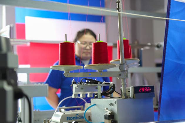 QINGDAO, CHINA - MAY 28: Workers are busy in front of an assembly line of flags for the FIFA World Cup at Qingdao Wonderful Flag Industry Co on May 28, 2026 in Qingdao, Shandong Province of China. As the 2026 FIFA World Cup is around the corner, production lines at a flag manufacturer in Qingdao, Shandong province, are running at full speed to produce various types of flags, many of which will soon appear in stadiums across North America.  Copyright: xVCGx 111644648660
