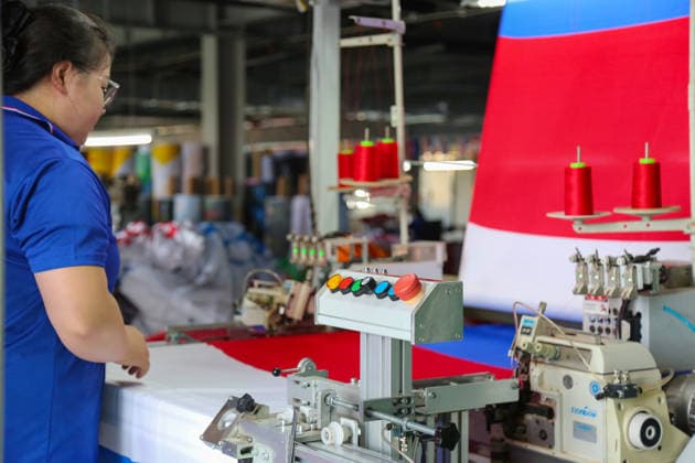 QINGDAO, CHINA - MAY 28: Workers are busy in front of an assembly line of flags for the FIFA World Cup at Qingdao Wonderful Flag Industry Co on May 28, 2026 in Qingdao, Shandong Province of China. As the 2026 FIFA World Cup is around the corner, production lines at a flag manufacturer in Qingdao, Shandong province, are running at full speed to produce various types of flags, many of which will soon appear in stadiums across North America.  Copyright: xVCGx 111644648661
