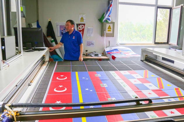 QINGDAO, CHINA - MAY 28: Workers are busy in front of an assembly line of flags for the FIFA World Cup at Qingdao Wonderful Flag Industry Co on May 28, 2026 in Qingdao, Shandong Province of China. As the 2026 FIFA World Cup is around the corner, production lines at a flag manufacturer in Qingdao, Shandong province, are running at full speed to produce various types of flags, many of which will soon appear in stadiums across North America.  Copyright: xVCGx 111644648662