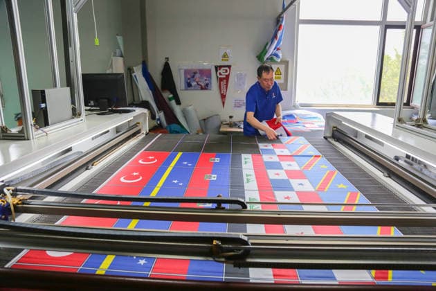 QINGDAO, CHINA - MAY 28: Workers are busy in front of an assembly line of flags for the FIFA World Cup at Qingdao Wonderful Flag Industry Co on May 28, 2026 in Qingdao, Shandong Province of China. As the 2026 FIFA World Cup is around the corner, production lines at a flag manufacturer in Qingdao, Shandong province, are running at full speed to produce various types of flags, many of which will soon appear in stadiums across North America.  Copyright: xVCGx 111644648663
