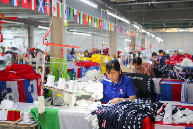QINGDAO, CHINA - MAY 28: Workers are busy in front of an assembly line of flags for the FIFA World Cup at Qingdao Wonderful Flag Industry Co on May 28, 2026 in Qingdao, Shandong Province of China. As the 2026 FIFA World Cup is around the corner, production lines at a flag manufacturer in Qingdao, Shandong province, are running at full speed to produce various types of flags, many of which will soon appear in stadiums across North America.  Copyright: xVCGx 111644648668