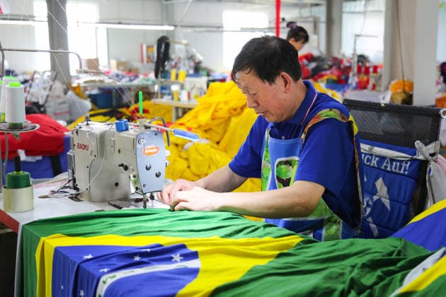 QINGDAO, CHINA - MAY 28: Workers are busy in front of an assembly line of flags for the FIFA World Cup at Qingdao Wonderful Flag Industry Co on May 28, 2026 in Qingdao, Shandong Province of China. As the 2026 FIFA World Cup is around the corner, production lines at a flag manufacturer in Qingdao, Shandong province, are running at full speed to produce various types of flags, many of which will soon appear in stadiums across North America.  Copyright: xVCGx 111644648669
