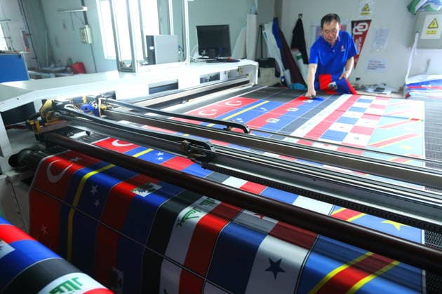 QINGDAO, CHINA - MAY 28: Workers are busy in front of an assembly line of flags for the FIFA World Cup at Qingdao Wonderful Flag Industry Co on May 28, 2026 in Qingdao, Shandong Province of China. As the 2026 FIFA World Cup is around the corner, production lines at a flag manufacturer in Qingdao, Shandong province, are running at full speed to produce various types of flags, many of which will soon appear in stadiums across North America.  Copyright: xVCGx 111644611661