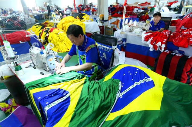 QINGDAO, CHINA - MAY 28: Workers are busy in front of an assembly line of flags for the FIFA World Cup at Qingdao Wonderful Flag Industry Co on May 28, 2026 in Qingdao, Shandong Province of China. As the 2026 FIFA World Cup is around the corner, production lines at a flag manufacturer in Qingdao, Shandong province, are running at full speed to produce various types of flags, many of which will soon appear in stadiums across North America.  Copyright: xVCGx 111644611664